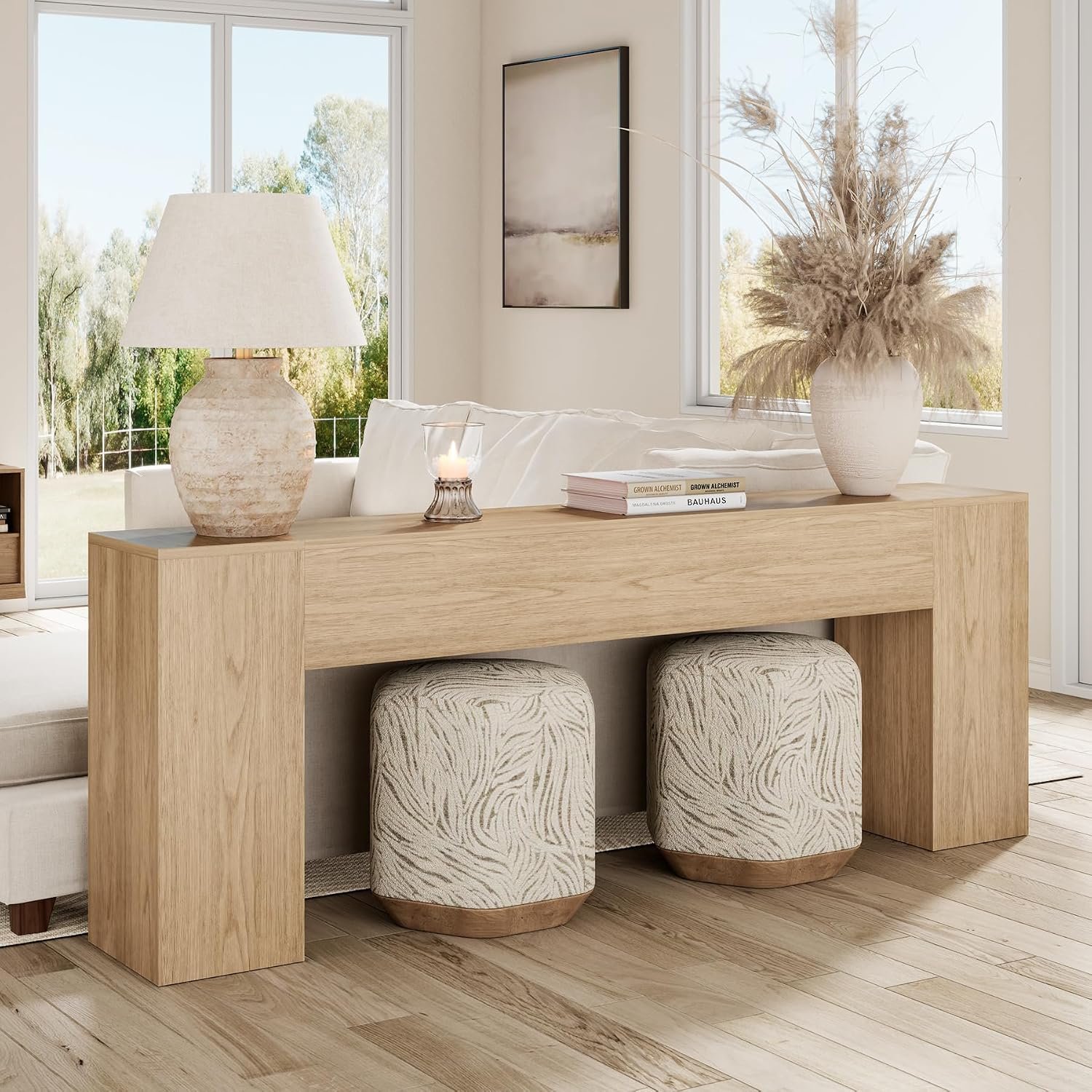 Large light oak console table styled in a modern entryway with ceramic vase and globe lamp