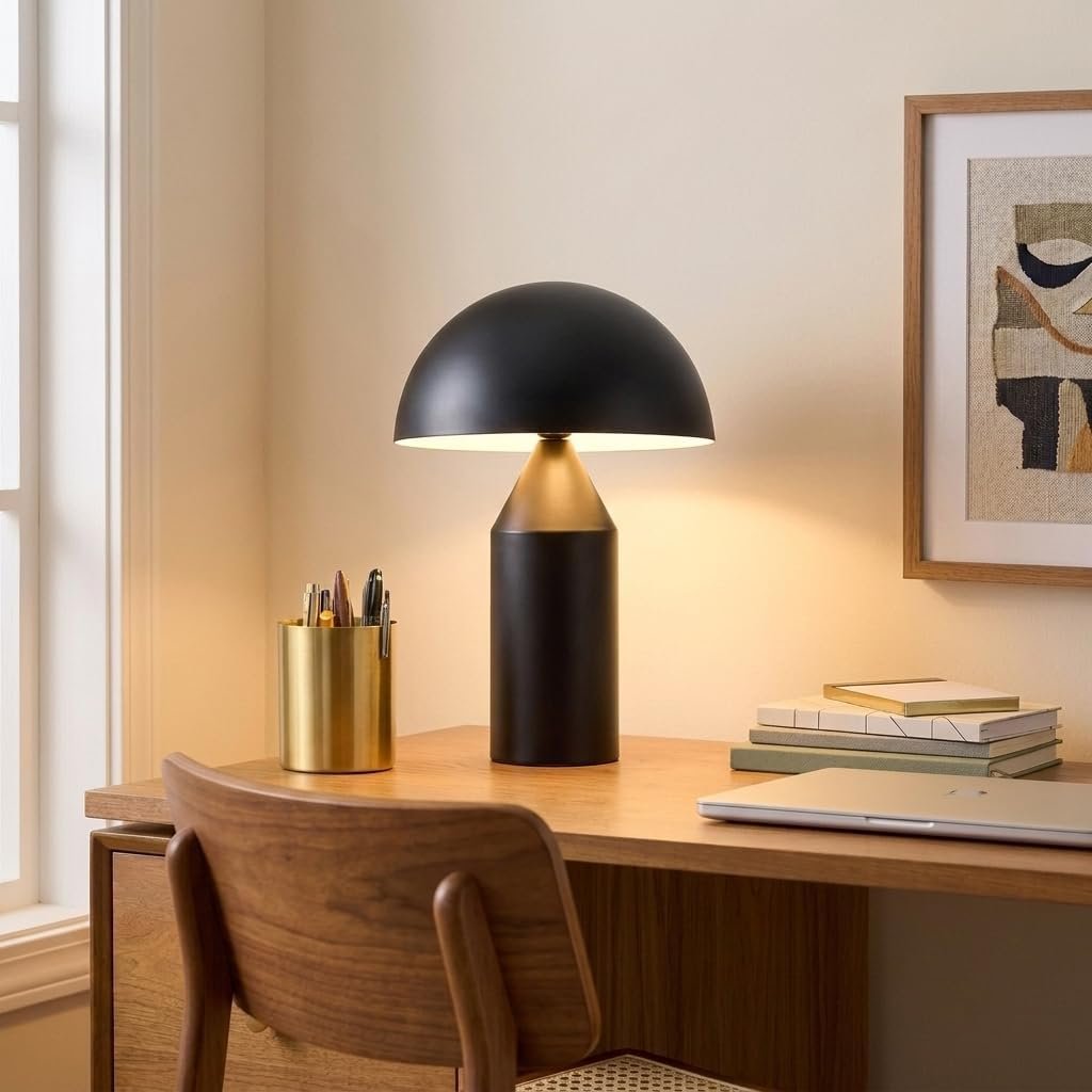 Black globe dome table lamp on a wood desk styled entryway console